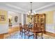 Dining room boasts hardwood floors, elegant chandelier, and ample natural light at 1311 Cobblemill Nw Way, Kennesaw, GA 30152