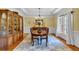 Traditional dining room with hardwood floors, china cabinet, and elegant chandelier at 1311 Cobblemill Nw Way, Kennesaw, GA 30152