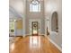 Spacious entryway features gleaming wood floors, high ceilings, decorative chandelier and arched doorways at 1311 Cobblemill Nw Way, Kennesaw, GA 30152