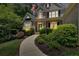 Well landscaped and maintained front yard showing walkway to home entrance at dusk at 1311 Cobblemill Nw Way, Kennesaw, GA 30152