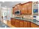 A kitchen featuring wood cabinetry, stainless steel appliances, and granite countertops at 1311 Cobblemill Nw Way, Kennesaw, GA 30152