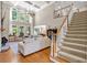 Bright living room with soaring ceilings, large windows, fireplace, hardwood floors and staircase at 1311 Cobblemill Nw Way, Kennesaw, GA 30152