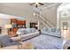 Bright and open living room with hardwood floors, staircase, and abundant natural light at 1311 Cobblemill Nw Way, Kennesaw, GA 30152