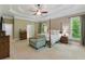 Spacious main bedroom featuring a four-poster bed, chair, large windows, and neutral decor at 1311 Cobblemill Nw Way, Kennesaw, GA 30152