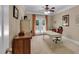 Well-lit office space with a ceiling fan, carpeted floors, and a desk with French doors that let in natural light at 1311 Cobblemill Nw Way, Kennesaw, GA 30152