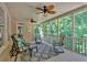 Relaxing screened porch with ceiling fans and comfortable seating, perfect for enjoying the outdoors at 1311 Cobblemill Nw Way, Kennesaw, GA 30152