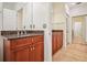 Well-lit bathroom features granite countertops, warm cabinets, and tiled floors at 2921 Lenox Rd # 308, Atlanta, GA 30324