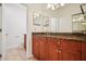 Bathroom featuring granite countertops, warm cabinets, and an adjacent toilet room at 2921 Lenox Rd # 308, Atlanta, GA 30324