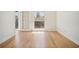 This bright bedroom features light hardwood floors, white walls, and a door to the outside at 2921 Lenox Rd # 308, Atlanta, GA 30324