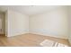 This bedroom features light hardwood floors, white walls, and a view into the next room at 2921 Lenox Rd # 308, Atlanta, GA 30324