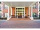 Grand building entrance with brick facade, stately columns, and inviting seating area providing a warm welcome at 2921 Lenox Rd # 308, Atlanta, GA 30324