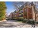 An impressive brick building boasts multiple stories, balconies, and lush landscaping, providing curb appeal at 2921 Lenox Rd # 308, Atlanta, GA 30324