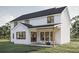 Exterior of a modern farmhouse featuring a covered porch and a patio with wicker furniture at 3629 Centerville Rosebud Rd, Snellville, GA 30039