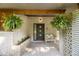 Inviting front porch with hanging ferns, seating, and decorative brickwork at 4020 N Cooper Lake Se Rd, Smyrna, GA 30082