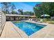 Backyard boasts a pristine pool with lounge chairs and colorful umbrellas, perfect for relaxation at 4020 N Cooper Lake Se Rd, Smyrna, GA 30082