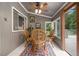 Bright sunroom with neutral paint, a decorative rug, and a small table with four wicker chairs at 4020 N Cooper Lake Se Rd, Smyrna, GA 30082