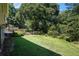 Large backyard with a meticulously maintained lawn, mature trees and a table to enjoy the outdoors at 437 Eastland Dr, Decatur, GA 30030
