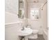 Classic white bathroom features a pedestal sink and a black and white checkered floor at 437 Eastland Dr, Decatur, GA 30030