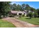 Ranch-style home featuring a driveway and accessible ramp leading to the front entrance at 437 Eastland Dr, Decatur, GA 30030