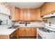 Functional kitchen features light wood cabinets, white countertops, and stainless steel sink at 437 Eastland Dr, Decatur, GA 30030