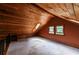 Finished attic space with wood paneling, small windows, and carpet flooring at 5780 Punkintown Rd, Douglasville, GA 30135