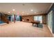 Finished basement offering ample space, stone fireplace, wood stairs, and abundant natural light from large windows at 5780 Punkintown Rd, Douglasville, GA 30135