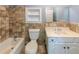 Bathroom featuring a tiled wall, bath and shower combo, toilet, vanity, and large mirror at 5780 Punkintown Rd, Douglasville, GA 30135