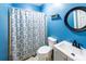 Bathroom features a toilet, vanity, and shower with a patterned shower curtain at 5780 Punkintown Rd, Douglasville, GA 30135