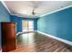 This bedroom features a wood-look floor and blue painted walls at 5780 Punkintown Rd, Douglasville, GA 30135