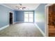 Bedroom has blue walls, white trim, carpet, and doors to a bathroom and a walk-in closet at 5780 Punkintown Rd, Douglasville, GA 30135