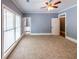 Bedroom features carpet, blue walls, white trim, a ceiling fan, and a window at 5780 Punkintown Rd, Douglasville, GA 30135