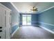 Spacious bedroom featuring neutral carpet, crown molding, and natural light from the large picture window at 5780 Punkintown Rd, Douglasville, GA 30135