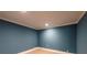 This bedroom features a neutral carpet and blue painted walls at 5780 Punkintown Rd, Douglasville, GA 30135