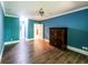 This bedroom features a wood-look floor and blue painted walls at 5780 Punkintown Rd, Douglasville, GA 30135