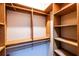 Walk-in closet with custom wood organizers for efficient storage at 5780 Punkintown Rd, Douglasville, GA 30135