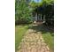 Charming home with a stone pathway, landscaped front yard, and a welcoming entrance at 5780 Punkintown Rd, Douglasville, GA 30135