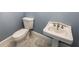 Classic half bath includes white fixtures, marble floors, a toilet, and a pedestal sink at 5780 Punkintown Rd, Douglasville, GA 30135