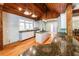 Bright kitchen boasts wood ceiling, center island, and stainless steel appliances at 5780 Punkintown Rd, Douglasville, GA 30135