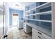Convenient laundry room featuring a washer and dryer, built-in shelving, and a countertop for folding at 5780 Punkintown Rd, Douglasville, GA 30135