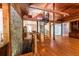 Spacious living room featuring a rock accent wall, wood floors, and a spiral staircase at 5780 Punkintown Rd, Douglasville, GA 30135