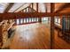 Spacious living room featuring wood ceiling, stone fireplace, wood floors, and exposed beams throughout the home at 5780 Punkintown Rd, Douglasville, GA 30135