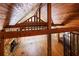 Spacious living room featuring wood ceiling, stone fireplace, wood floors, and exposed beams throughout the home at 5780 Punkintown Rd, Douglasville, GA 30135
