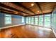 Bright living room with hardwood floors, wood-paneled ceiling, and an abundance of natural light at 5780 Punkintown Rd, Douglasville, GA 30135