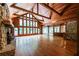 Spacious living room with soaring wood ceiling, stone fireplace, and plenty of natural light at 5780 Punkintown Rd, Douglasville, GA 30135
