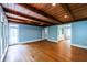 Spacious living room with wood-paneled ceiling, hardwood floors, and multiple windows for natural light at 5780 Punkintown Rd, Douglasville, GA 30135