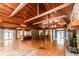 Open-concept living room with hardwood floors, stone fireplace, wood ceiling, and a spiral staircase at 5780 Punkintown Rd, Douglasville, GA 30135