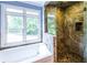 Inviting bathroom with a tub, separate shower, and large windows overlooking a wooded area at 5780 Punkintown Rd, Douglasville, GA 30135