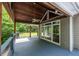 Covered porch featuring wood ceiling, ceiling fan, and scenic views of the outdoors at 5780 Punkintown Rd, Douglasville, GA 30135