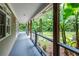 Covered porch with wood posts and a view of the lush landscape, perfect for relaxing and enjoying nature at 5780 Punkintown Rd, Douglasville, GA 30135