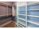 This walk-in closet boasts ample storage with custom shelves and multiple rods for optimal organization at 5780 Punkintown Rd, Douglasville, GA 30135